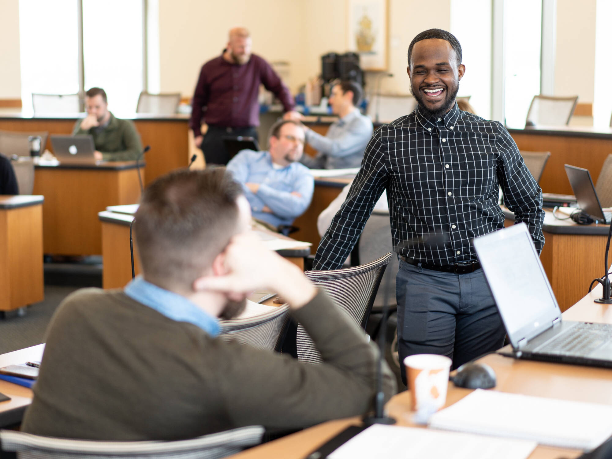 Two students chatting in a classroom at Seidman College of Business